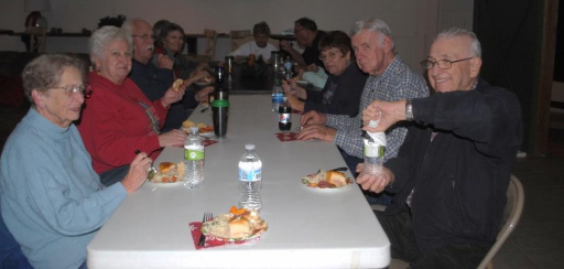 Group of people eating at a table.